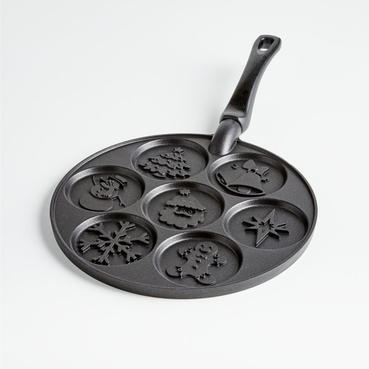 Nordic Ware Holiday Pancake Pan showing all seven embossed holiday mold cavities and phenolic handle