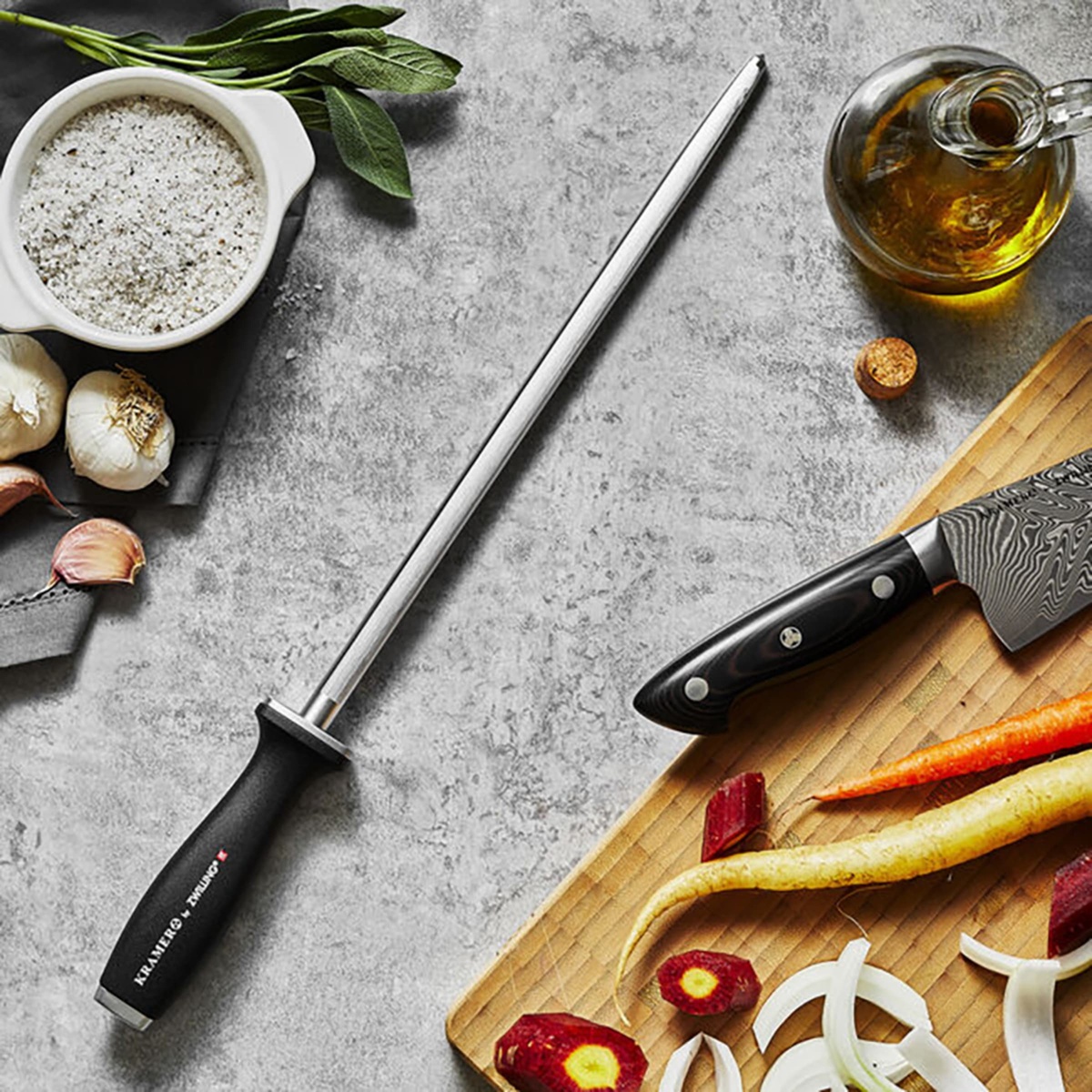Zwilling Kramer honing steel on a kitchen counter next to a chef knife and vegetables