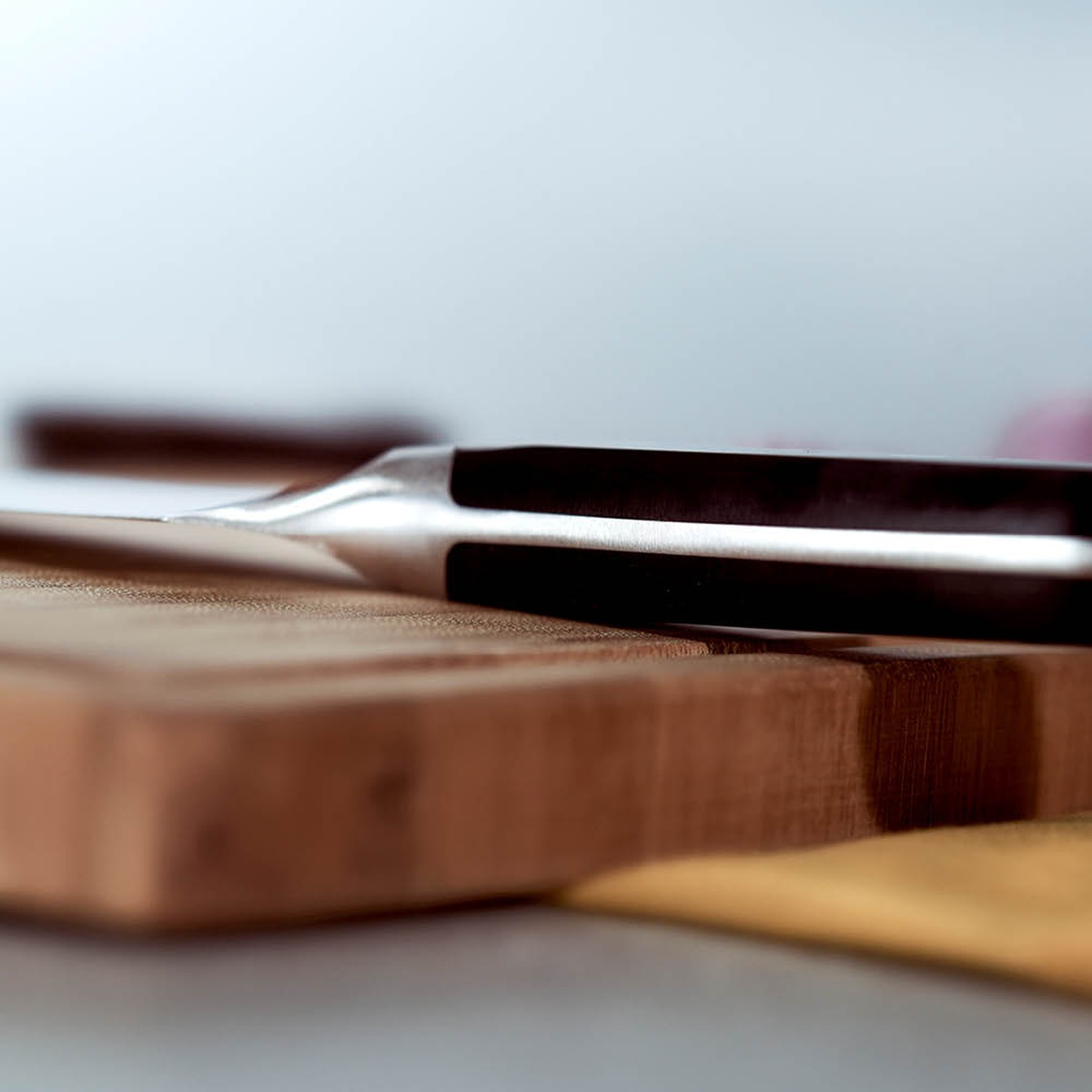 Close-up view of the innovative curved bolster and triple-riveted handle of the Zwilling Pro knife