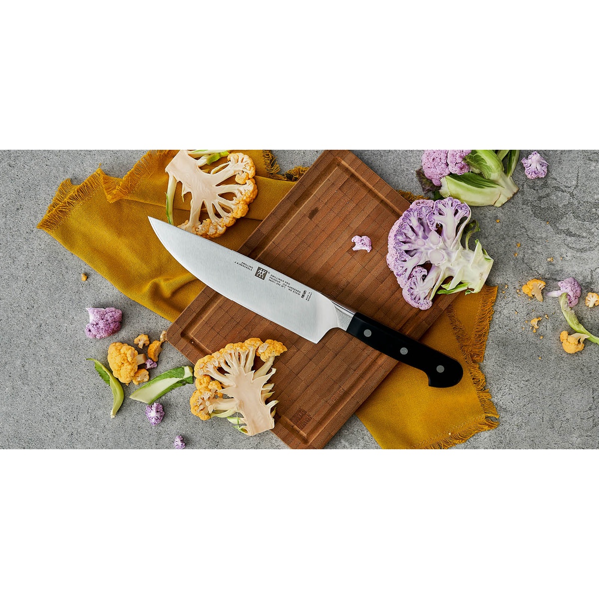 Zwilling Pro knife on a cutting board surrounded by colorful cauliflower