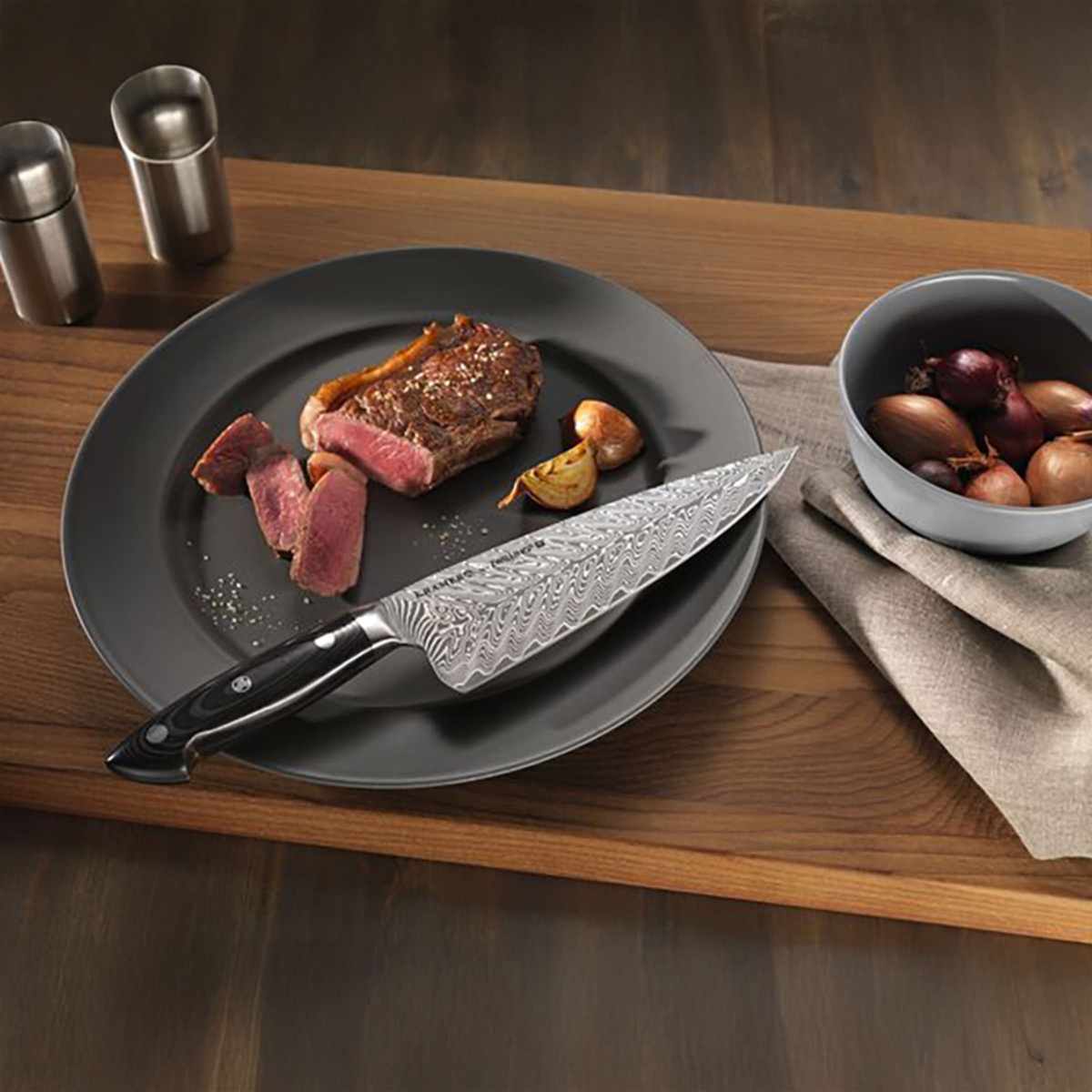 Zwilling Kramer Euroline Chef Knife on a plate with sliced steak