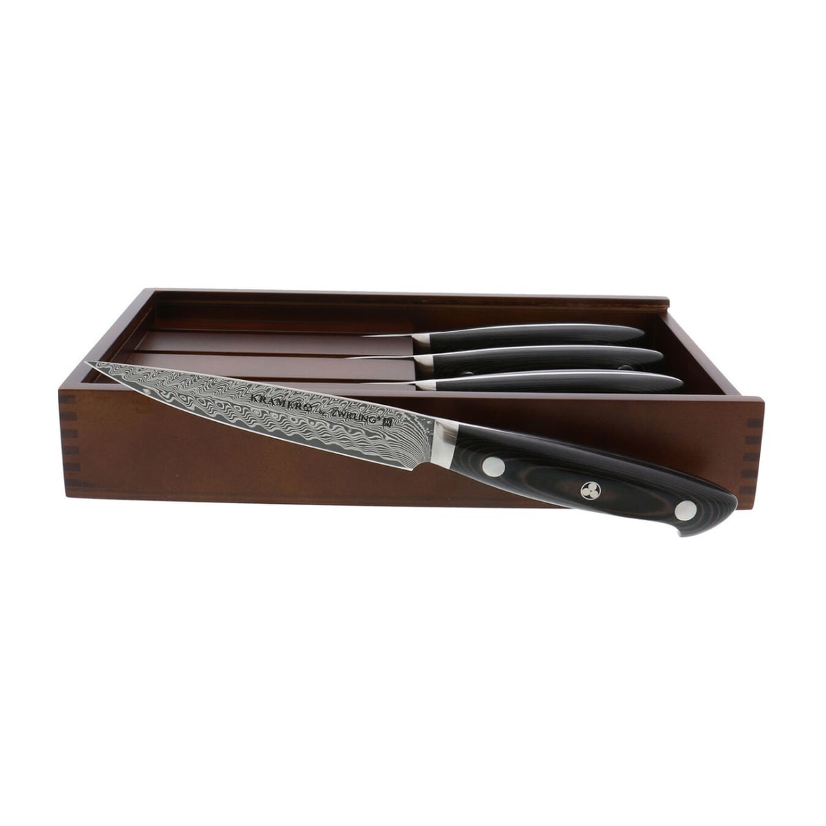 Set of four Zwilling Kramer Euroline steak knives with Damascus blades displayed in a wooden storage box