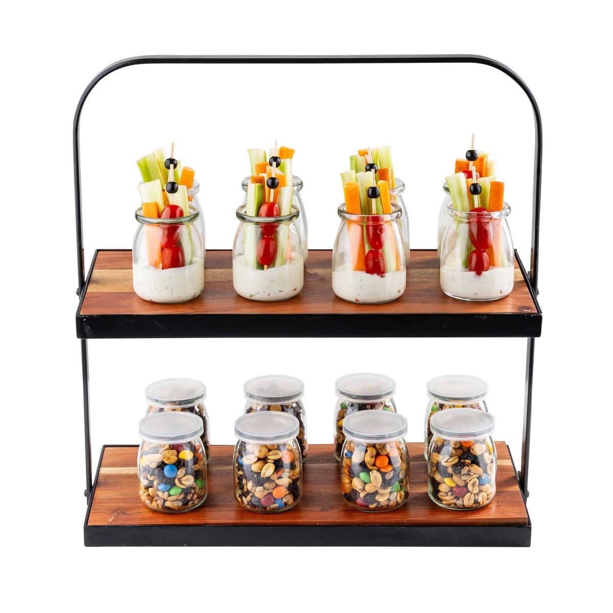 TableCraft two-tiered acacia wood display stand holding small glass jars of trail mix and veggie snack cups on each shelf, against a white background
