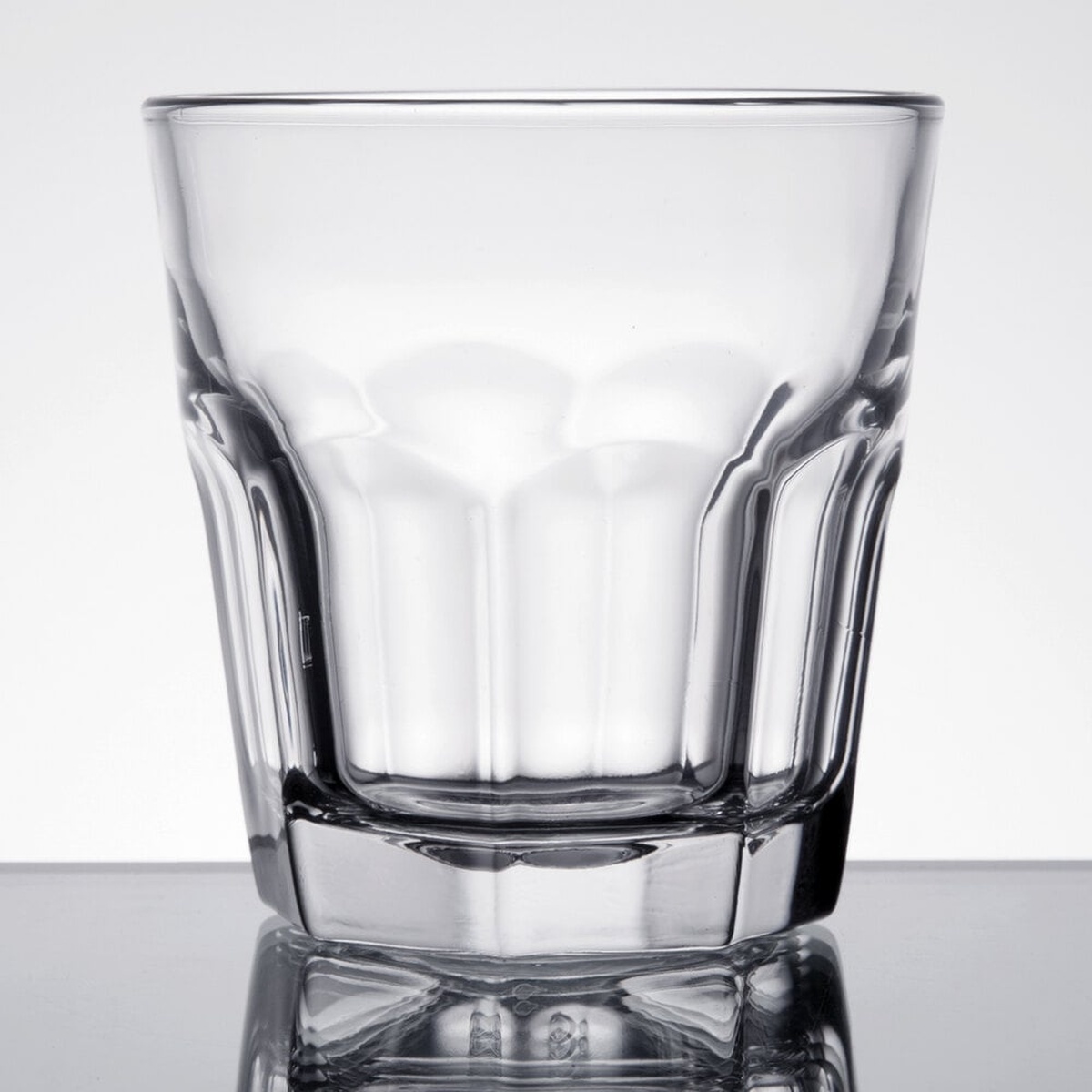 Libbey Gibraltar 9 oz rocks glass with architectural paneled body and thick base, side view on white background
