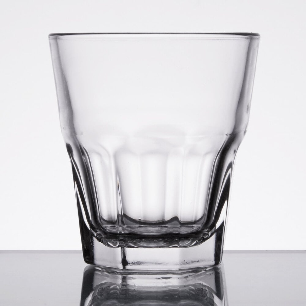Libbey Gibraltar 5.5 oz rocks glass on reflective white surface showing paneled geometric construction