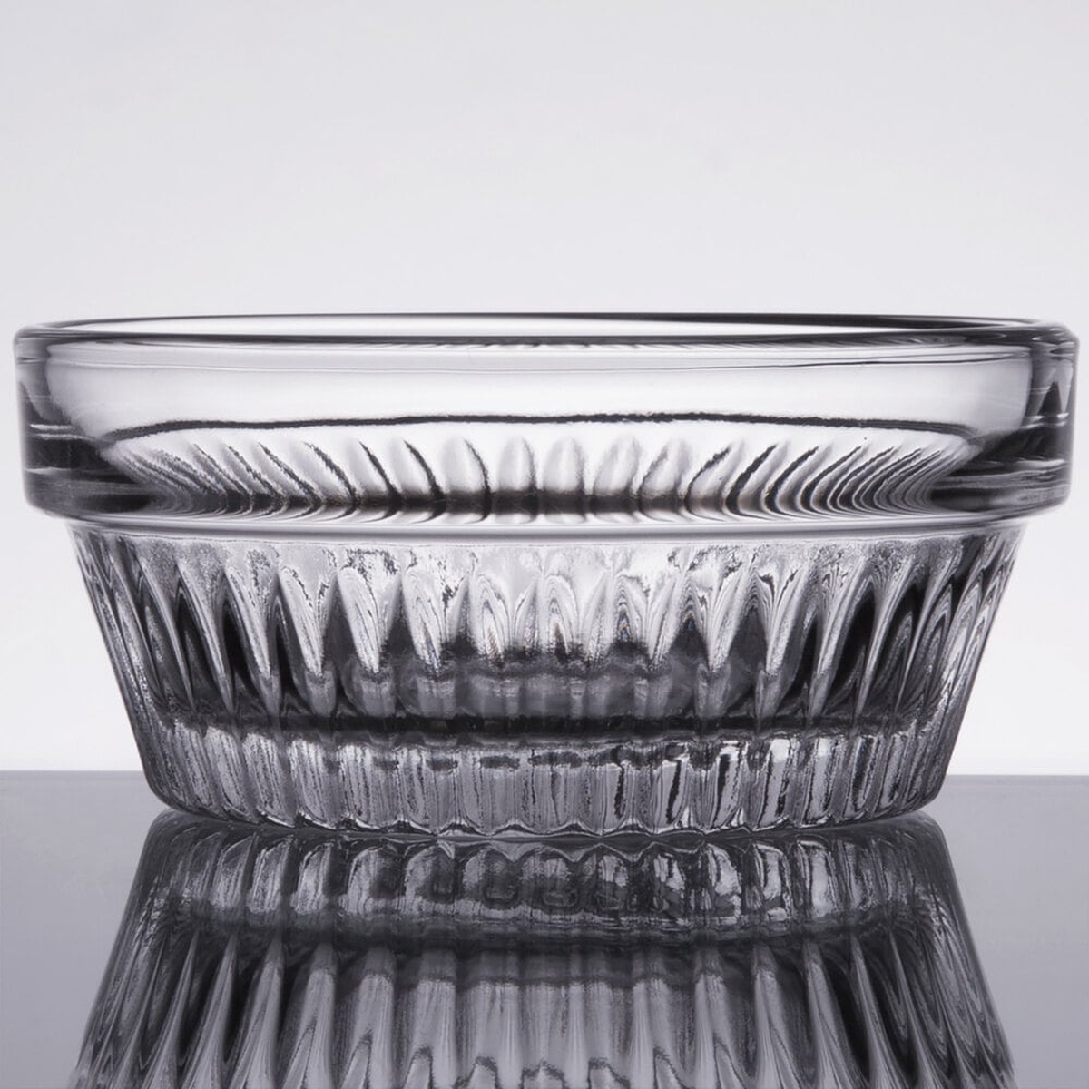 Libbey Winchester 3 oz. clear glass ramekin with textured peaked ridges on a reflective surface