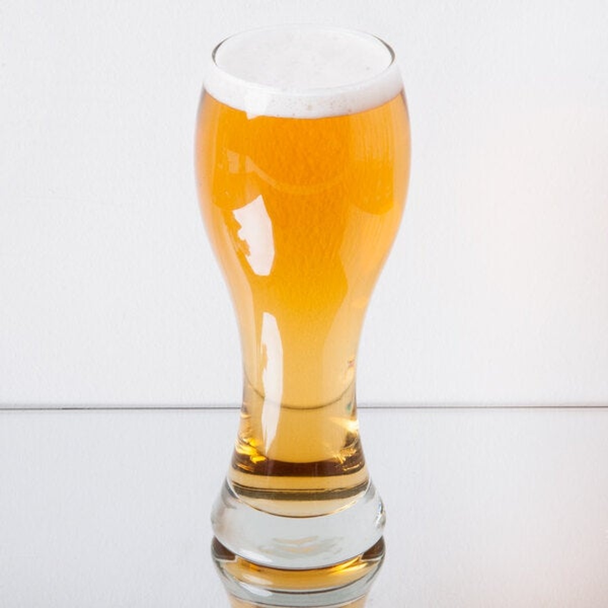 Libbey 1611 giant pilsner glass filled with golden beer and a white foam head