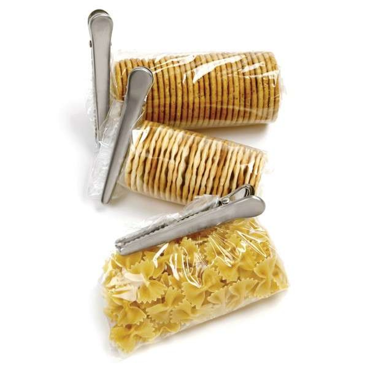 Three Norpro stainless steel jaw clips sealing bags of crackers and bow-tie pasta on a white background