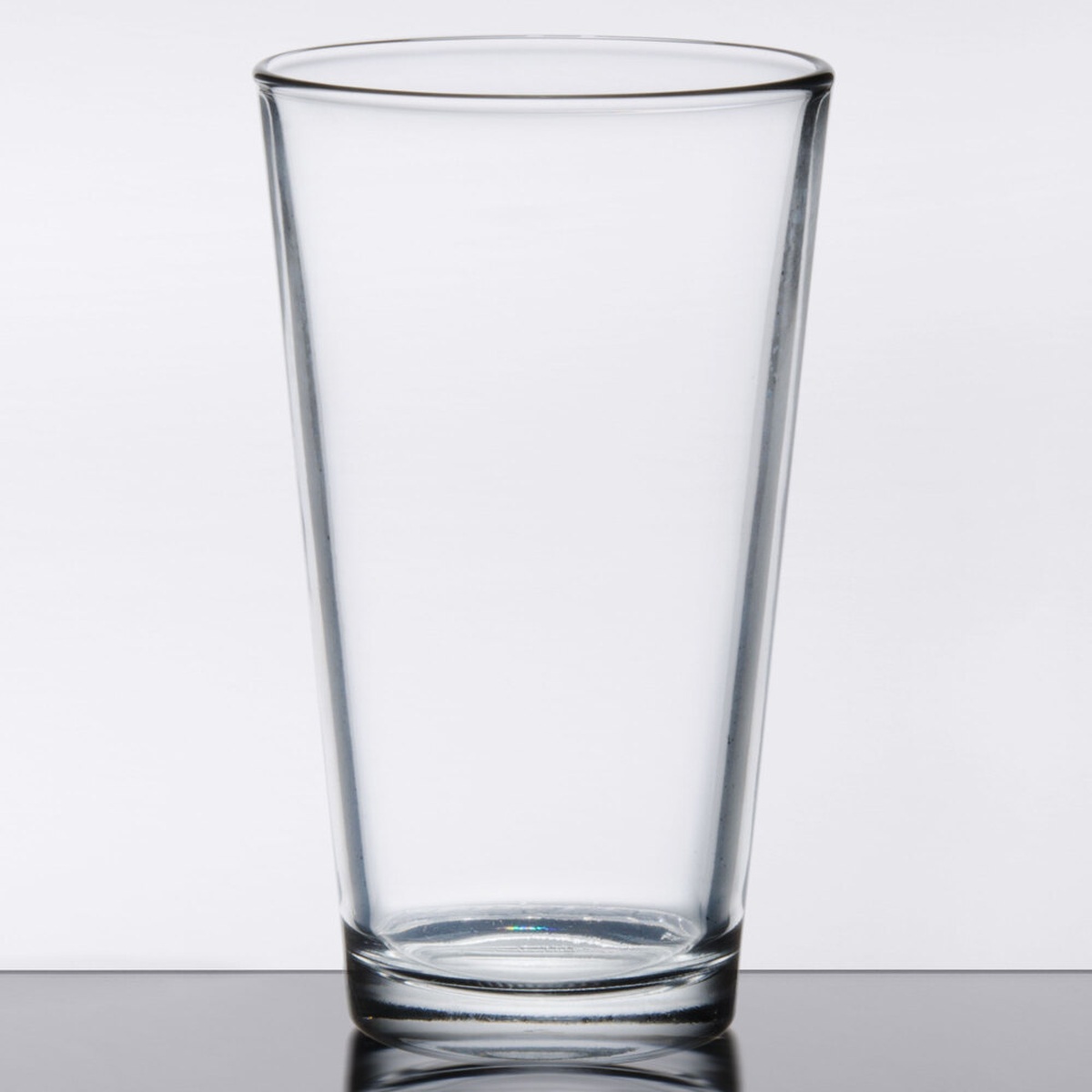 Libbey 1637HT 20 oz. clear mixing glass with tapered conical shape on reflective surface