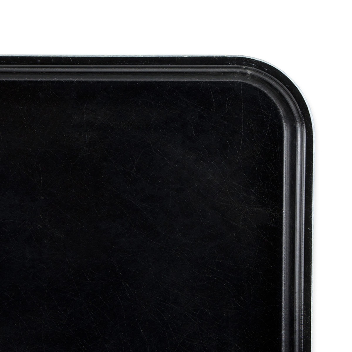 Close-up corner detail of the Cambro 1826MT110 black fiberglass market display tray showing molded rim edge