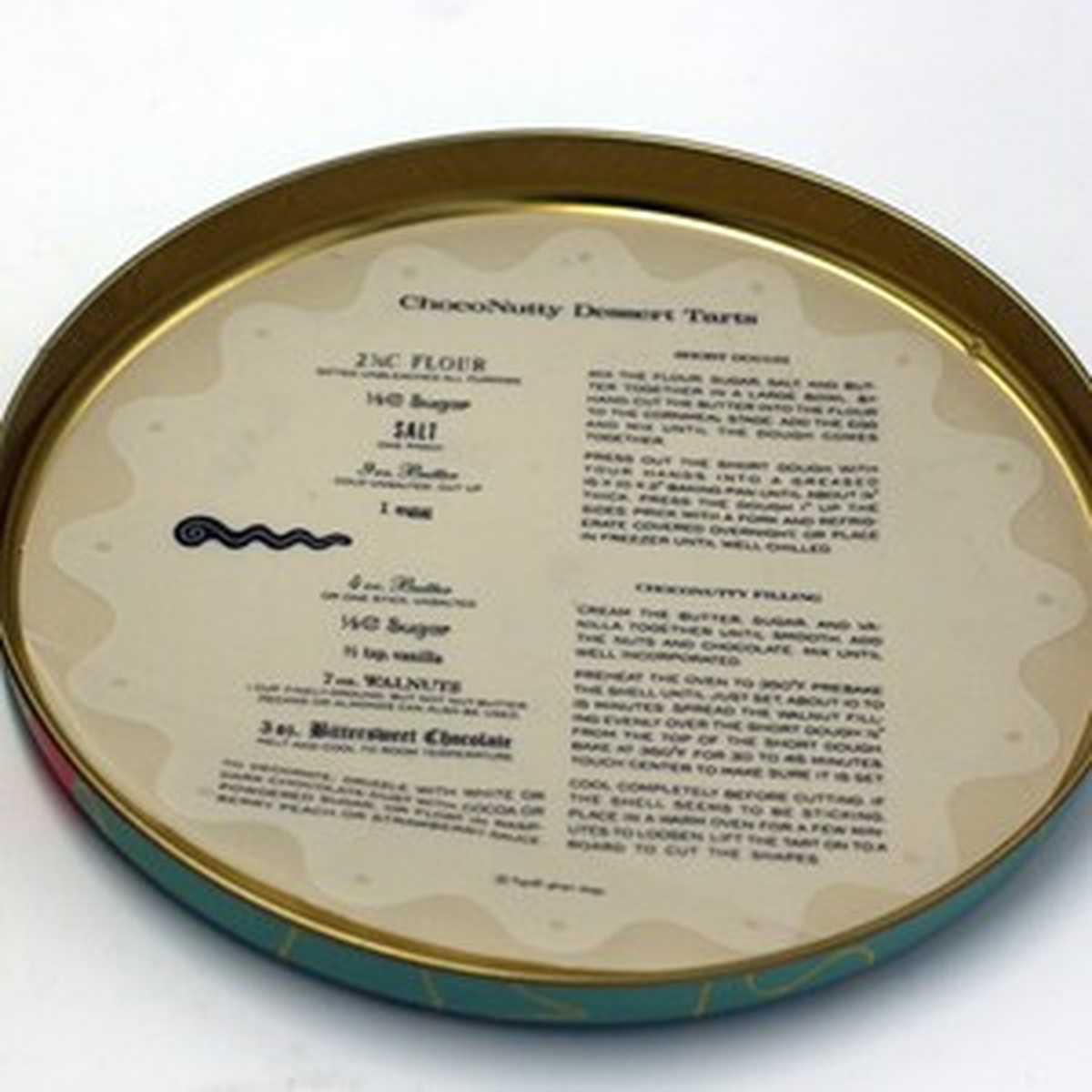 Inside of Kooky Cutters tin lid featuring a ChocoNutty Dessert Tarts recipe card