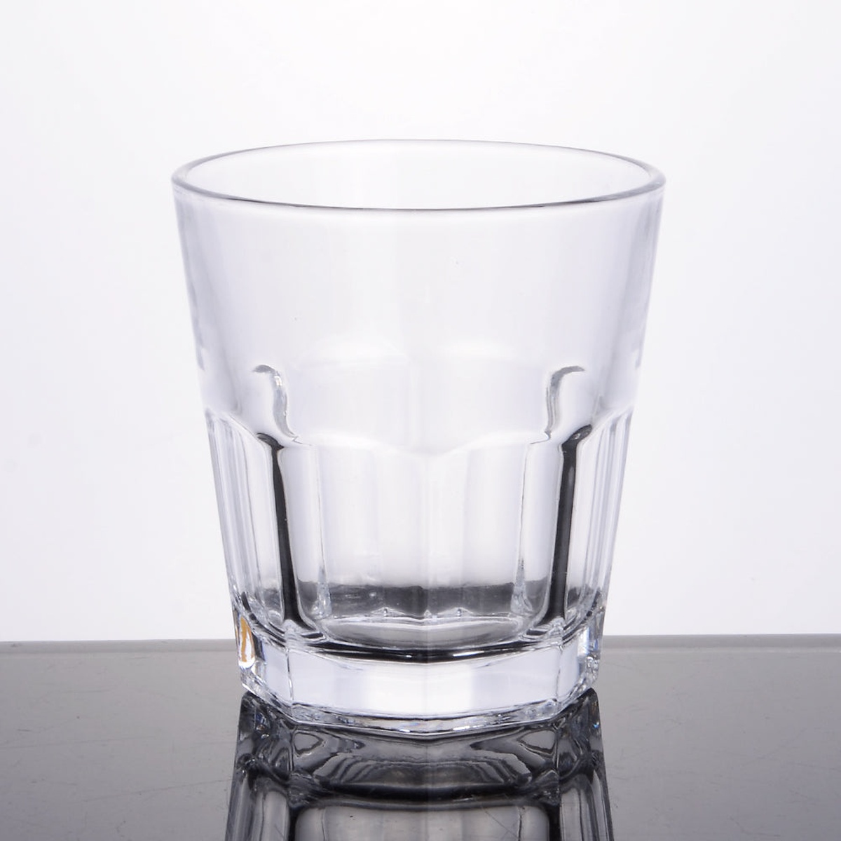 Enhanced Glassware 12 oz glass tumbler upright, showing faceted base and tapered sides