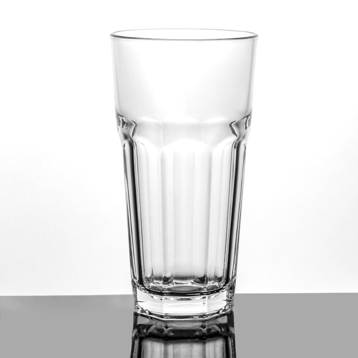 Enhanced Glassware 2016LB 16 oz. clear cooler glass tumbler with ribbed sides on a reflective surface