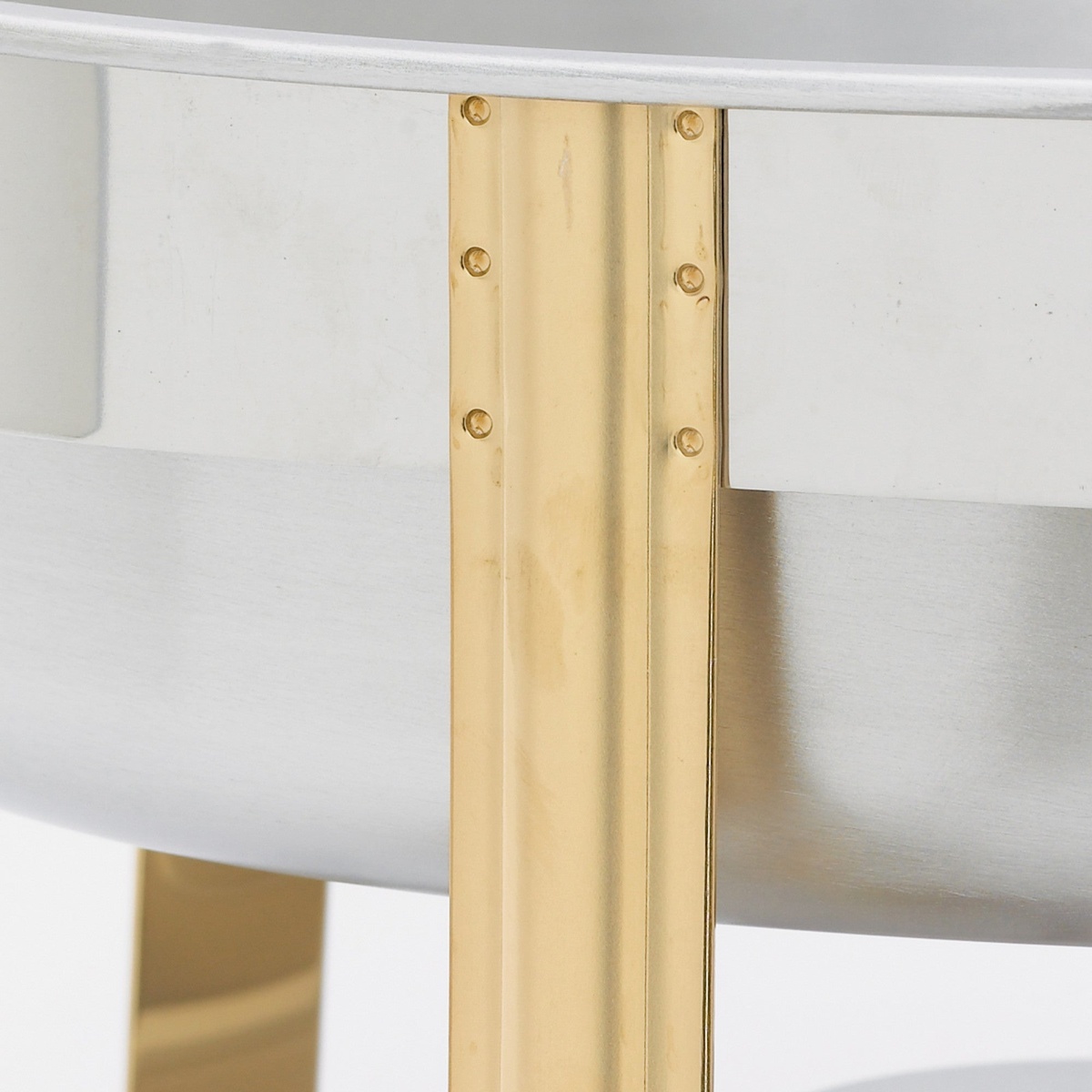 Close-up of the triple-riveted gold-tone leg on the Winco 202 Malibu chafer showing durable construction detail