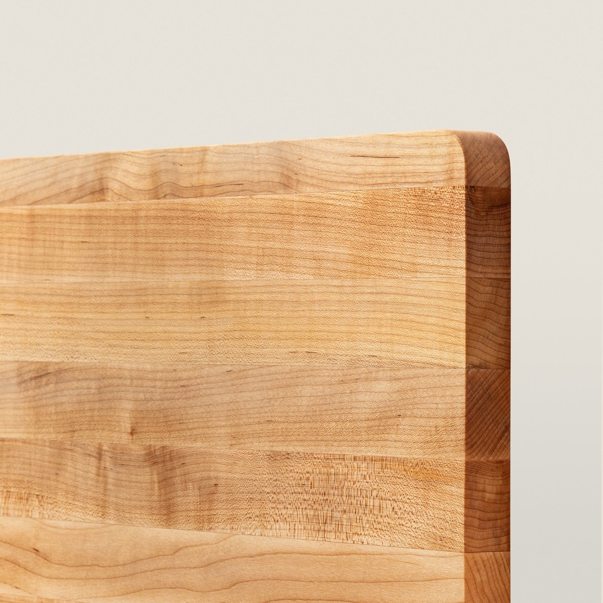 Close-up detail of John Boos 214 maple cutting board showing edge-grain wood construction and eased corner