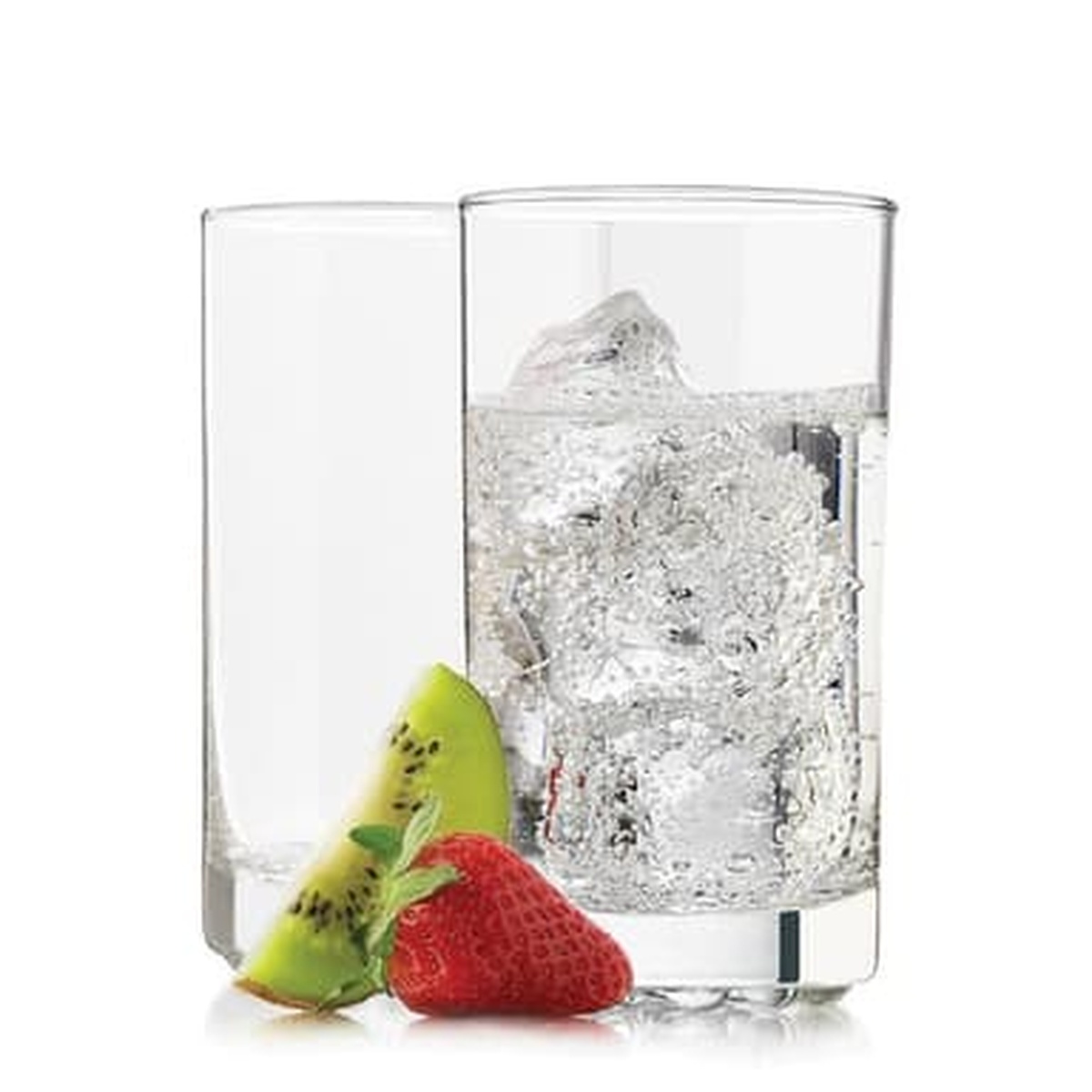 Two Libbey Nob Hill highball glasses filled with iced water, styled with fresh fruit on white background