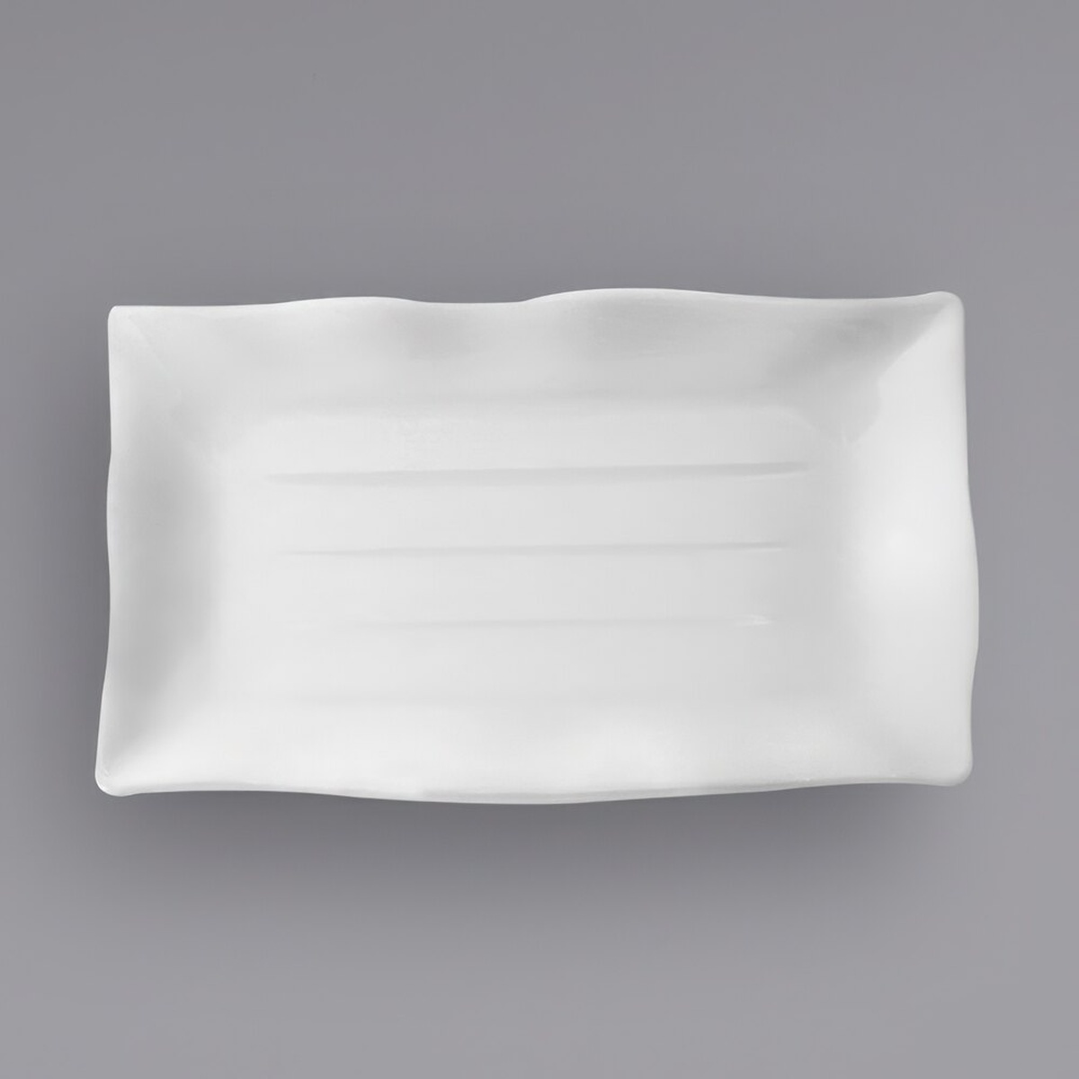 Thunder Group 24140WT white rectangular melamine wave plate, top-down view showing wavy edge and ribbed surface texture