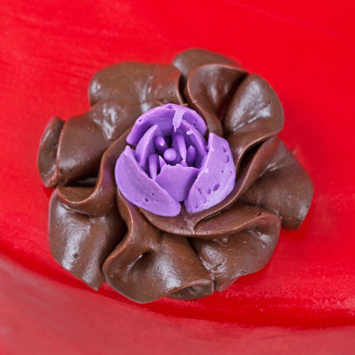 Chocolate and purple frosting floral decoration piped using the Ateco 244 Russian piping tip