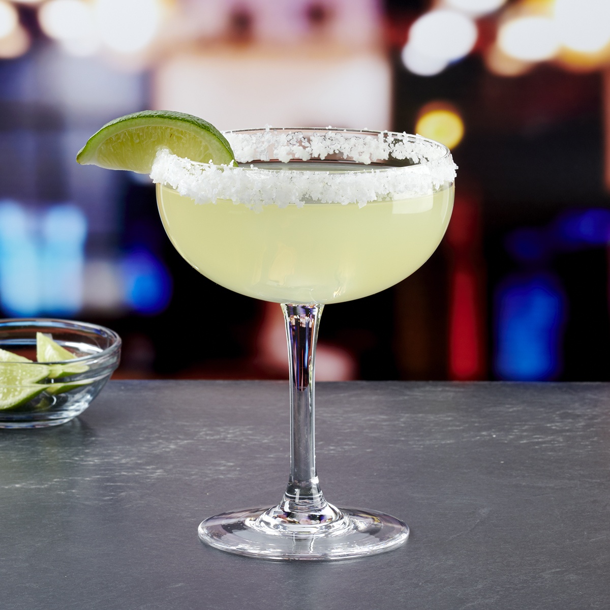 Anchor Hocking 2914UX 14 oz. Excellency Margarita Glass with salted rim and lime garnish