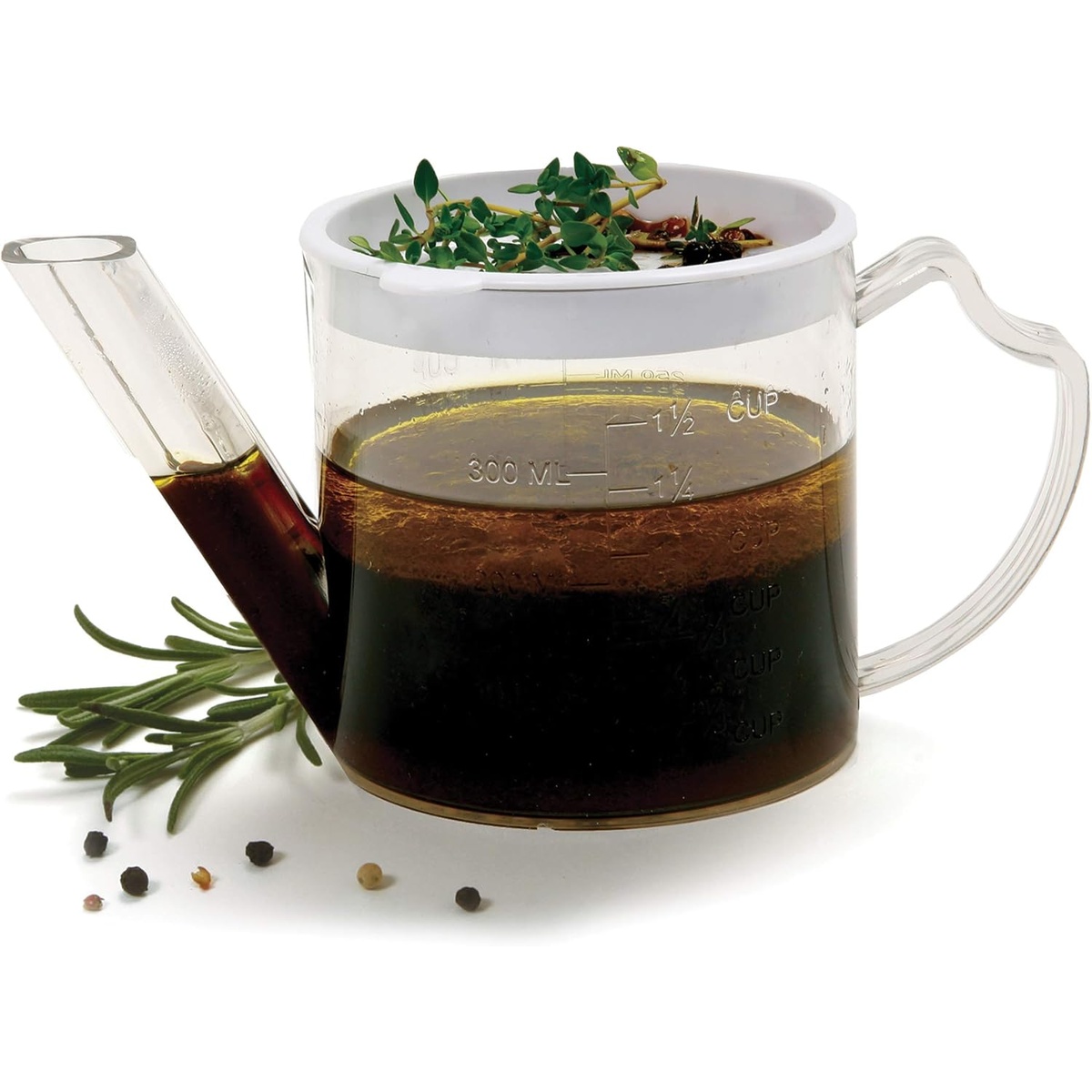 Norpro 3023 clear plastic fat separator filled with layered drippings, removable strainer on top, surrounded by fresh herbs and peppercorns