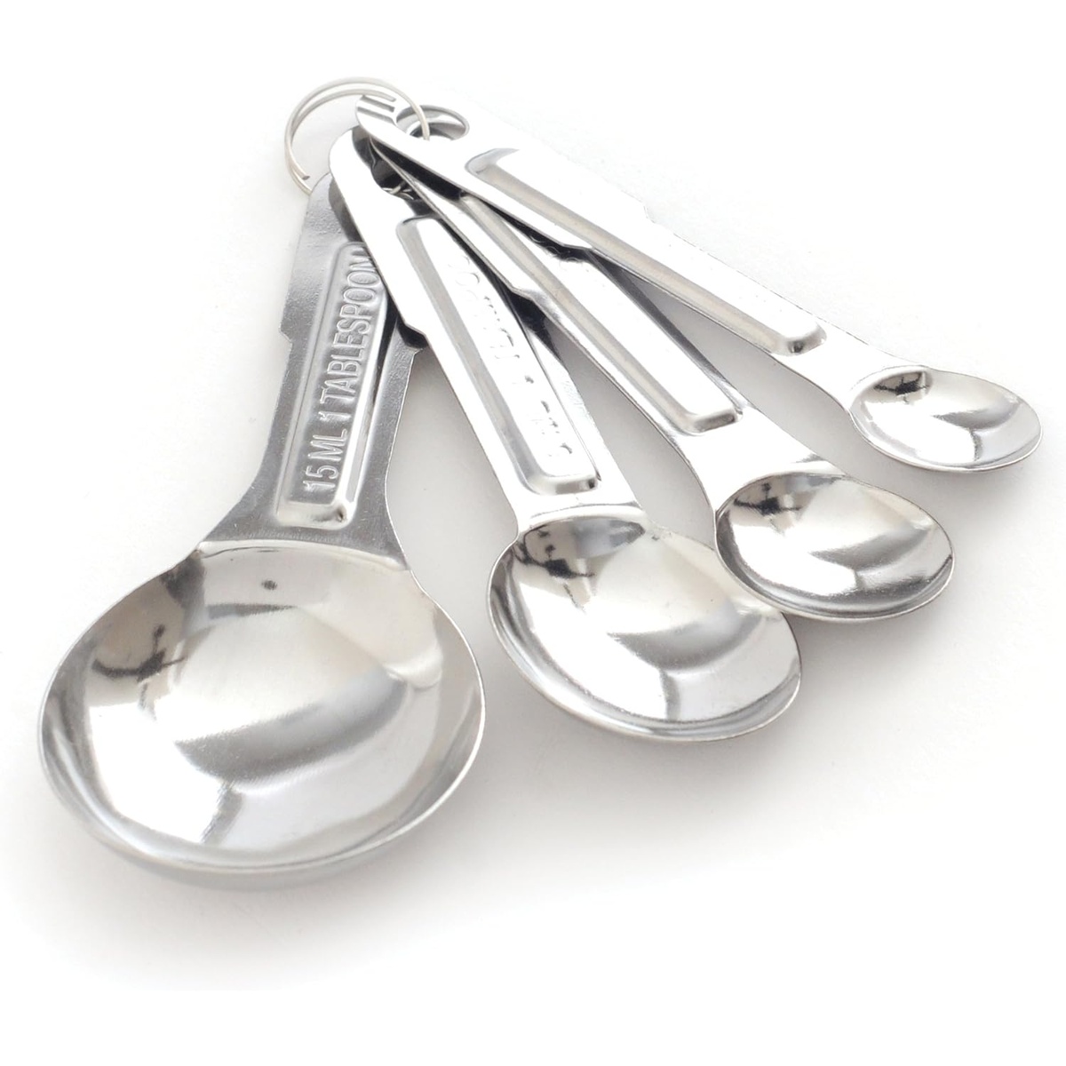 Norpro stainless steel measuring spoon set fanned out showing engraved 15ml 1 tablespoon marking and connecting ring