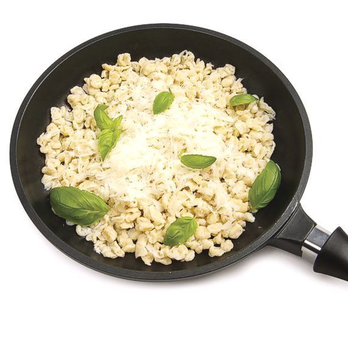 A pan filled with freshly cooked spaetzle dumplings topped with cheese and herbs