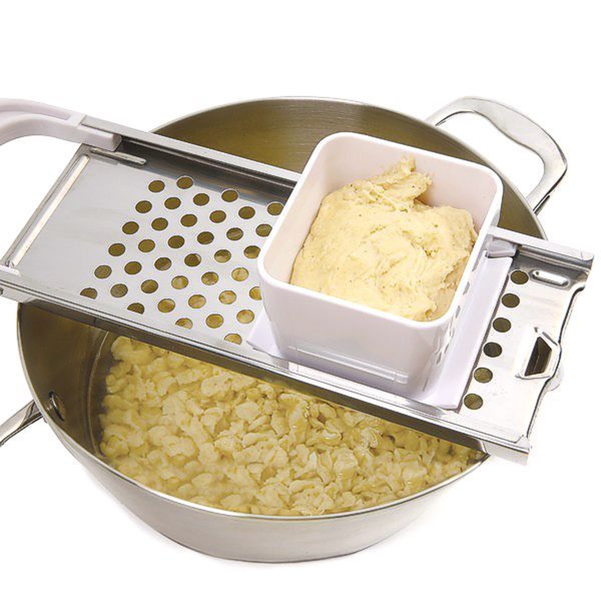 Norpro spaetzle maker being used over a pot of boiling water to create fresh dumplings