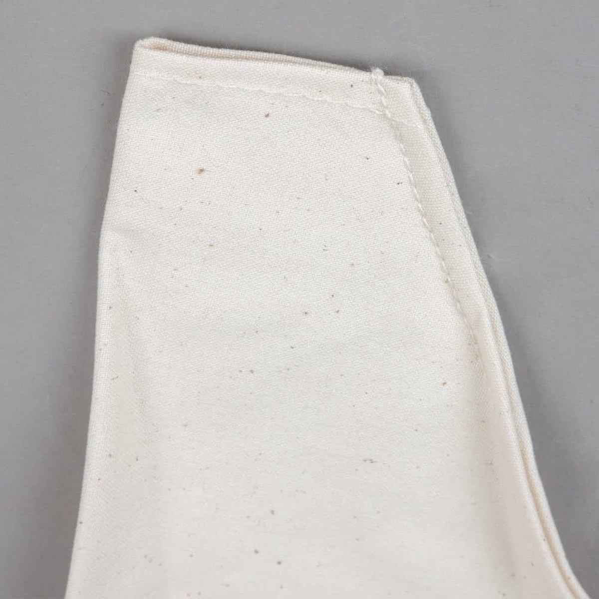 Close-up of the Ateco canvas pastry bag top showing the stitched seam and hemmed construction detail