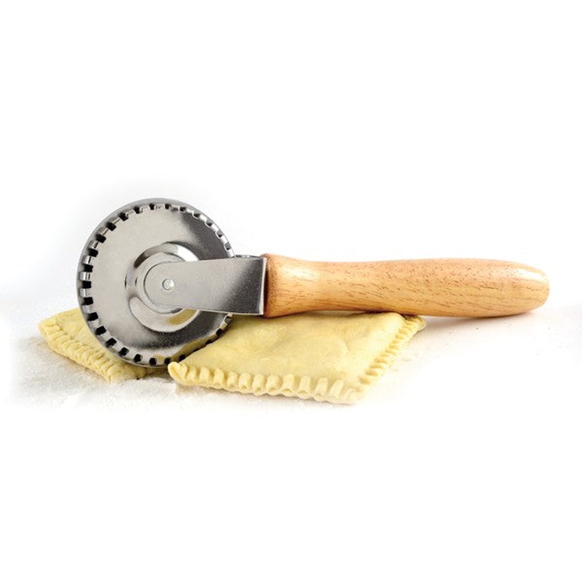Norpro 3248 pastry crimper resting on a crimped square of pastry dough showing finished seal