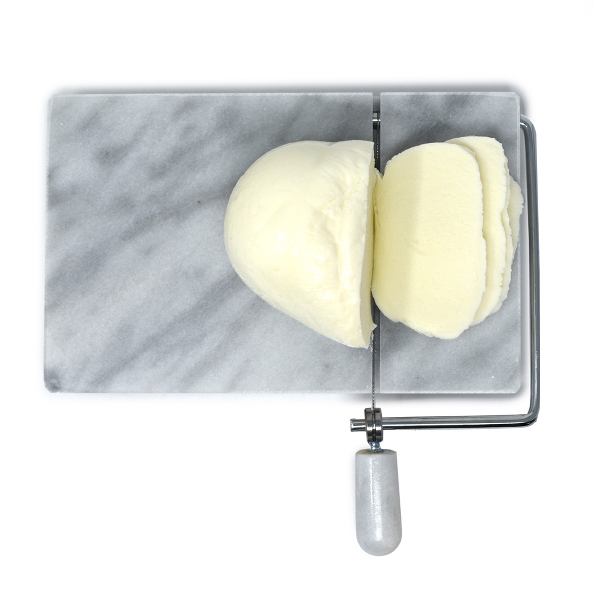 Top-down view of the marble slicer cutting a ball of fresh mozzarella cheese