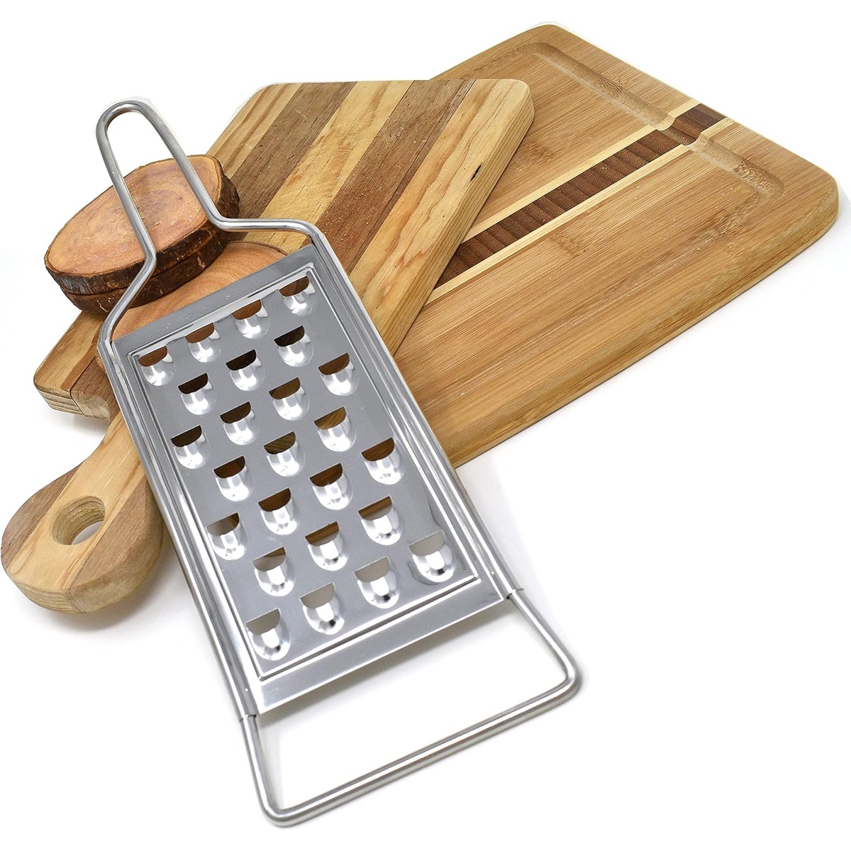 Norpro 355 stainless steel potato grater leaning upright against wooden cutting boards on a white background