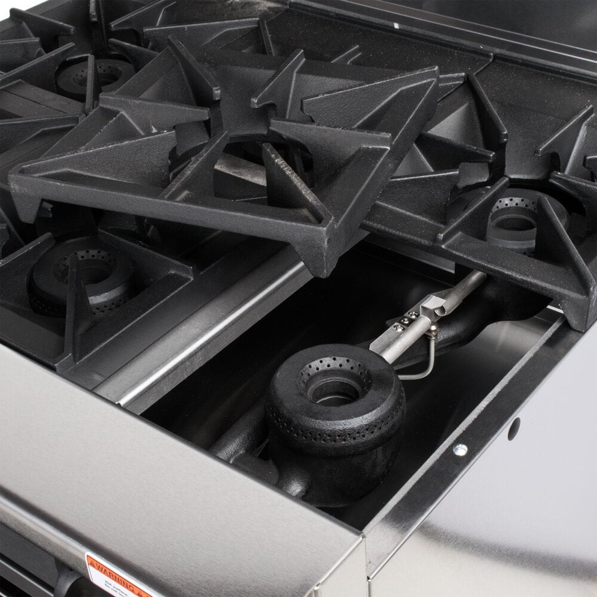 Close-up of lift-off cast iron grates and burner head on Vulcan open burner range