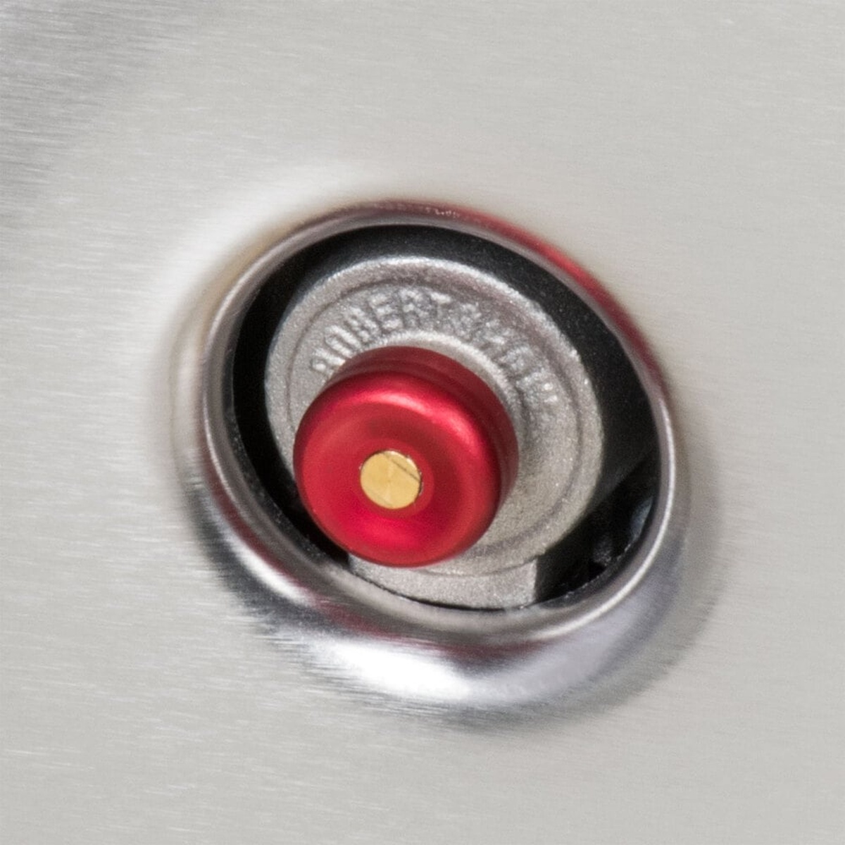 Close-up of manual rotary piezo igniter button on Vulcan gas range