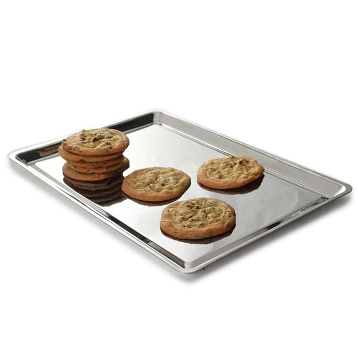 Stainless steel baking pan with freshly baked chocolate chip cookies resting on its reflective surface