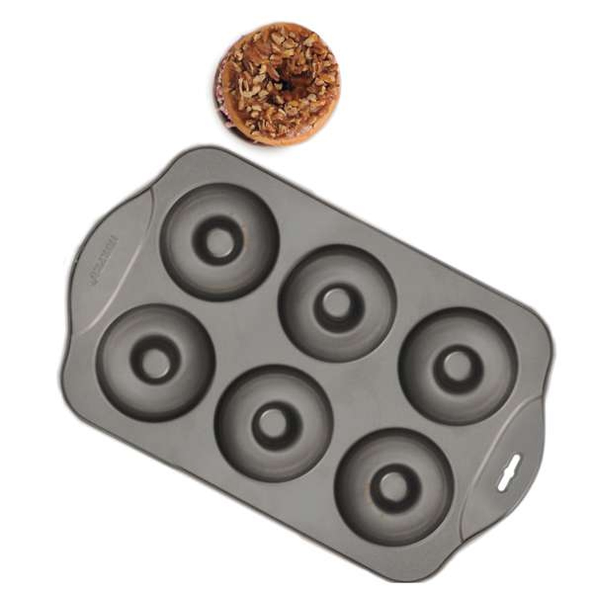 Top view of Norpro donut pan showing six round cavities alongside a nut-topped baked donut