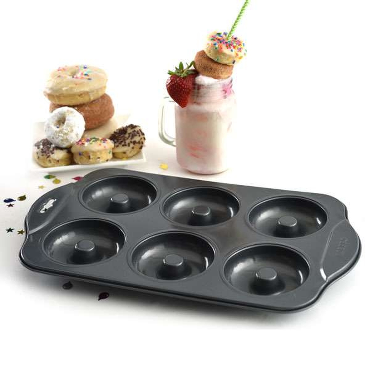 Norpro 6-count donut pan displayed alongside a colorful assortment of baked donuts