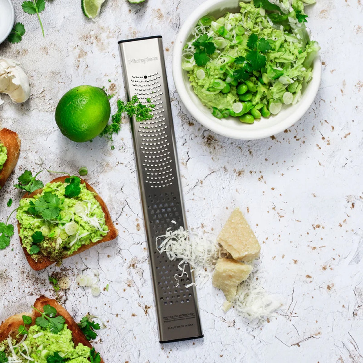 Microplane grater shown with prepared avocado toast and garnishes