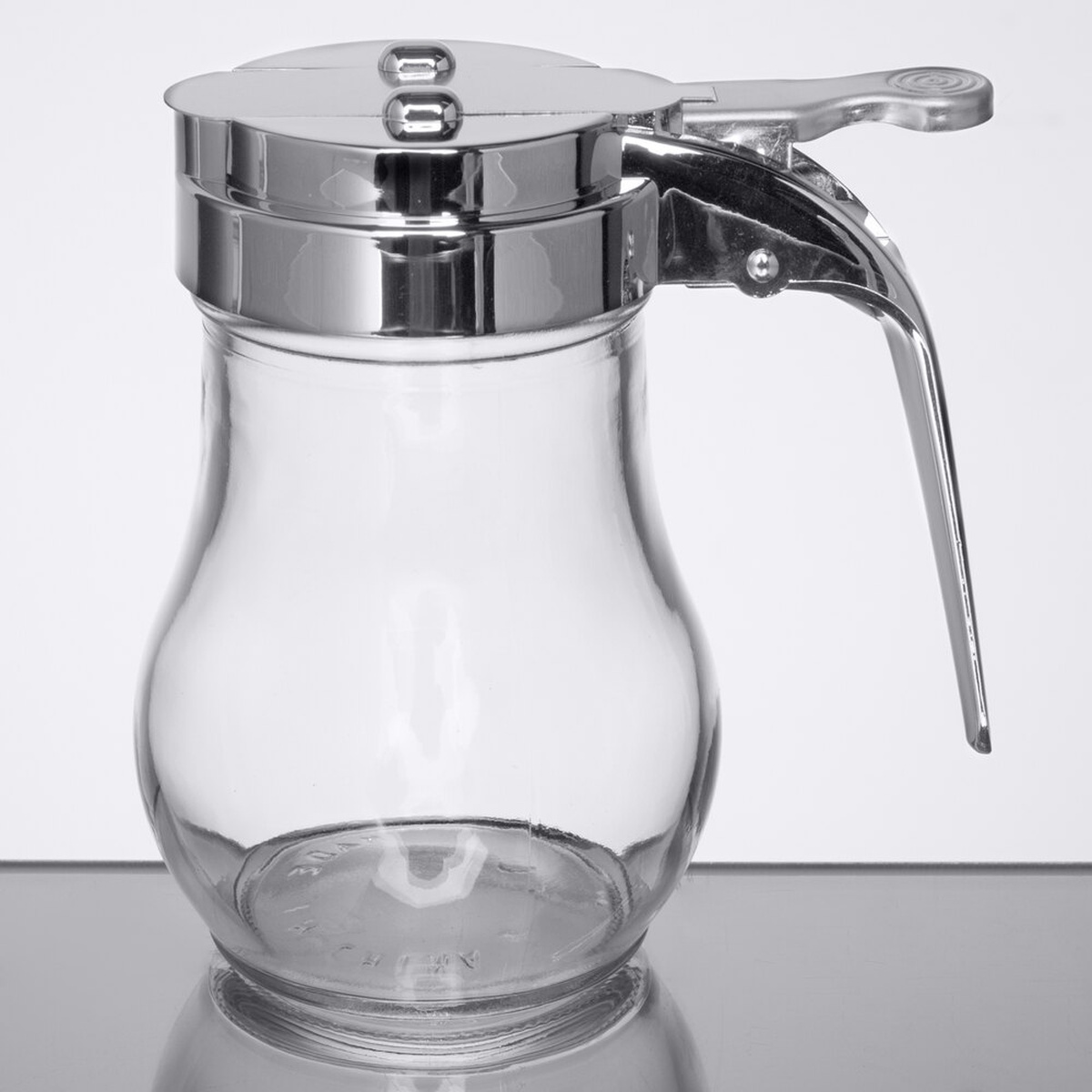 TableCraft 406CP 6 oz. glass teardrop syrup dispenser with chrome-plated ABS top and thumb lever handle