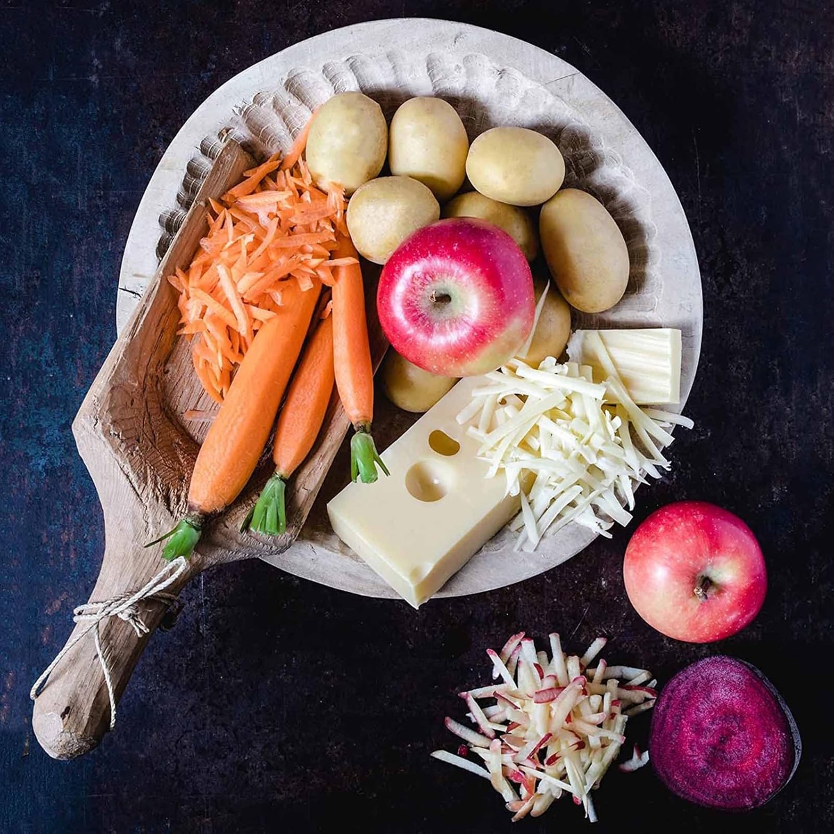 Assorted fresh vegetables and cheese prepared for grating