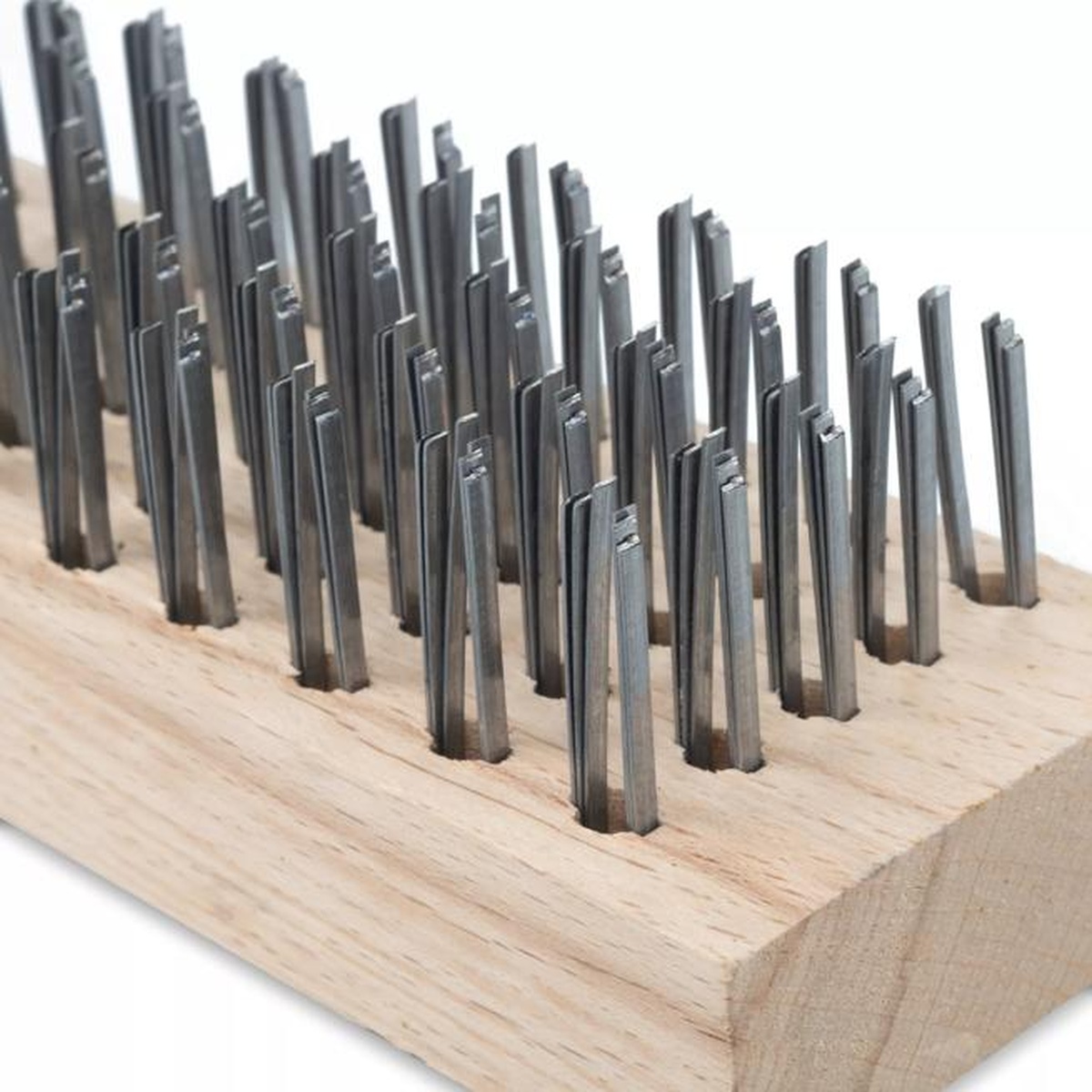 Close-up detail of tempered steel wire bristles embedded in the wooden block of the Carlisle butcher block brush