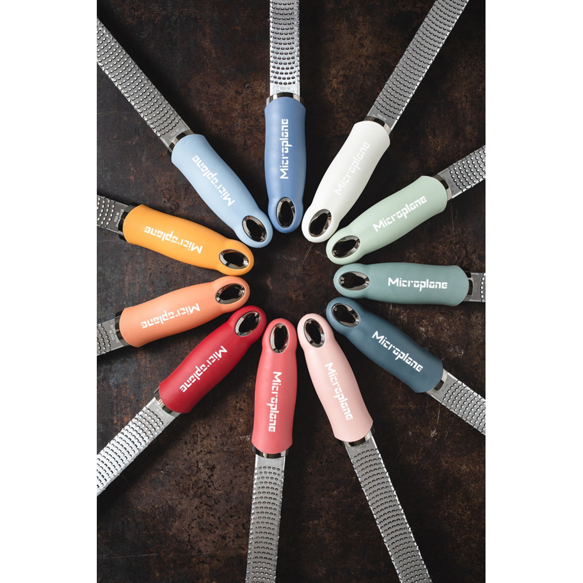 Multiple Microplane Premium Classic Zester Graters arranged in a circular fan pattern showing the full range of handle colors