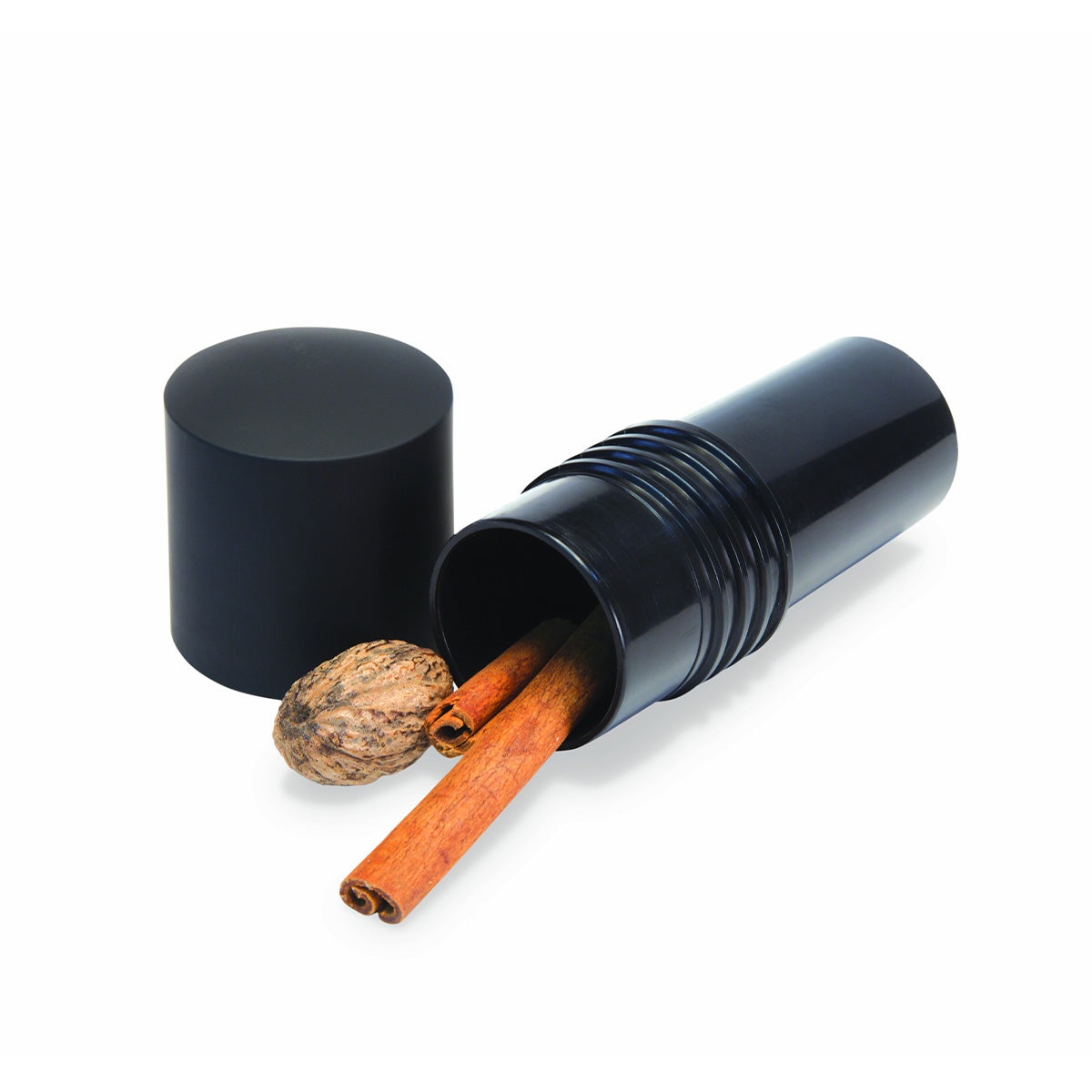 Internal view of the spice mill storage compartment containing whole cinnamon sticks and nutmeg