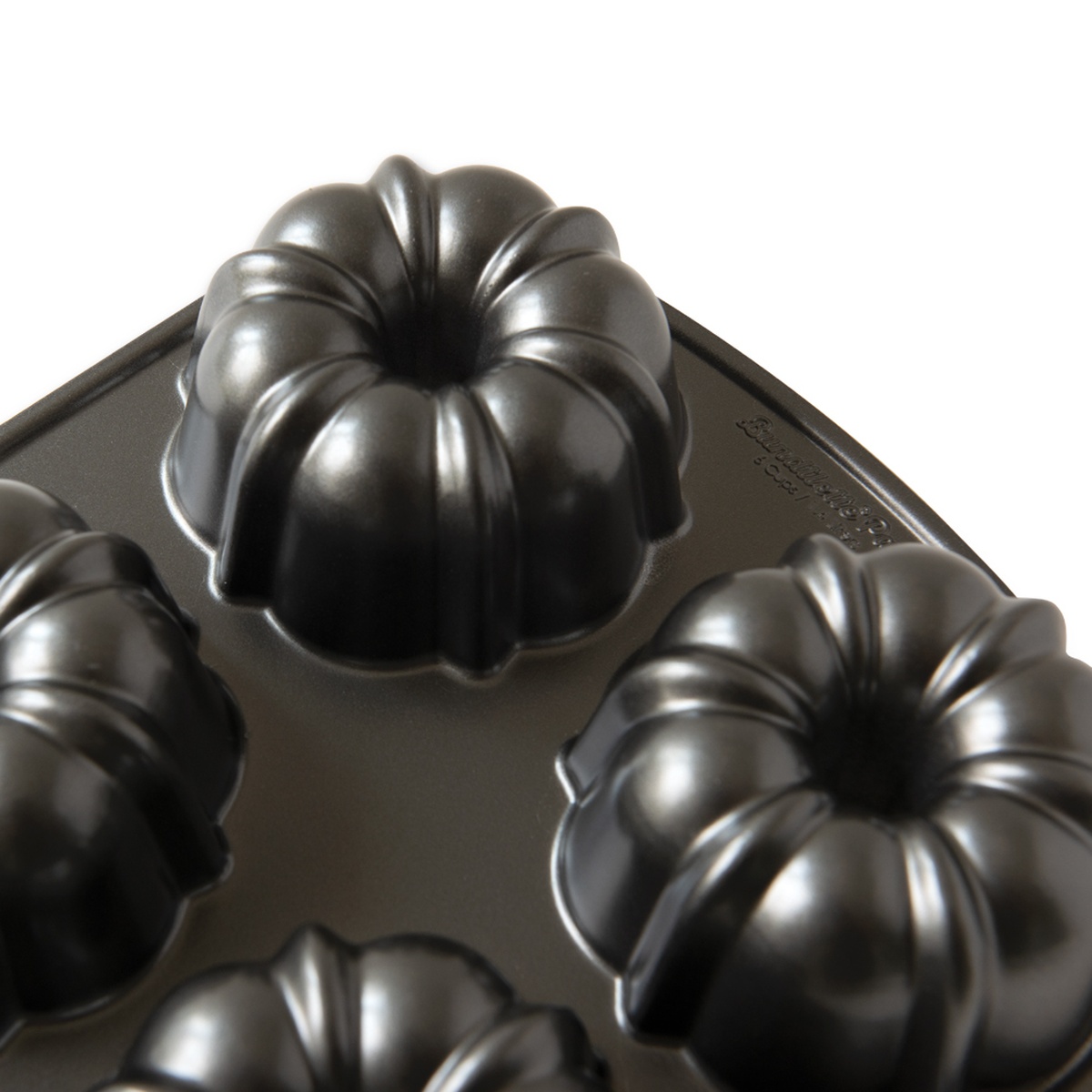 Close-up detail of Nordic Ware mini Bundt pan showing raised fluted mold detail and non-stick coating