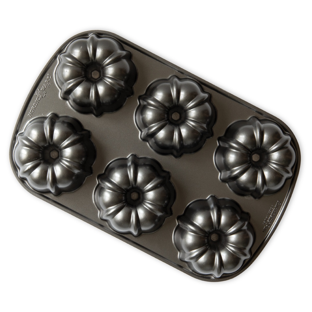 Nordic Ware 6-cavity mini floral Bundt pan with dark non-stick coating viewed from above