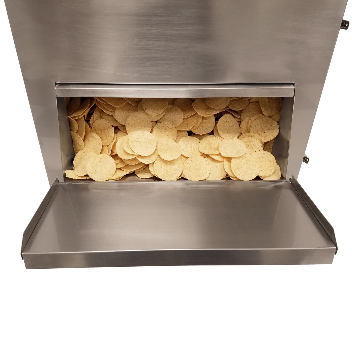 Interior front-access dispensing door open on the BenchmarkUSA chip warmer, revealing a full load of warm tortilla chips and a stainless steel serving tray below
