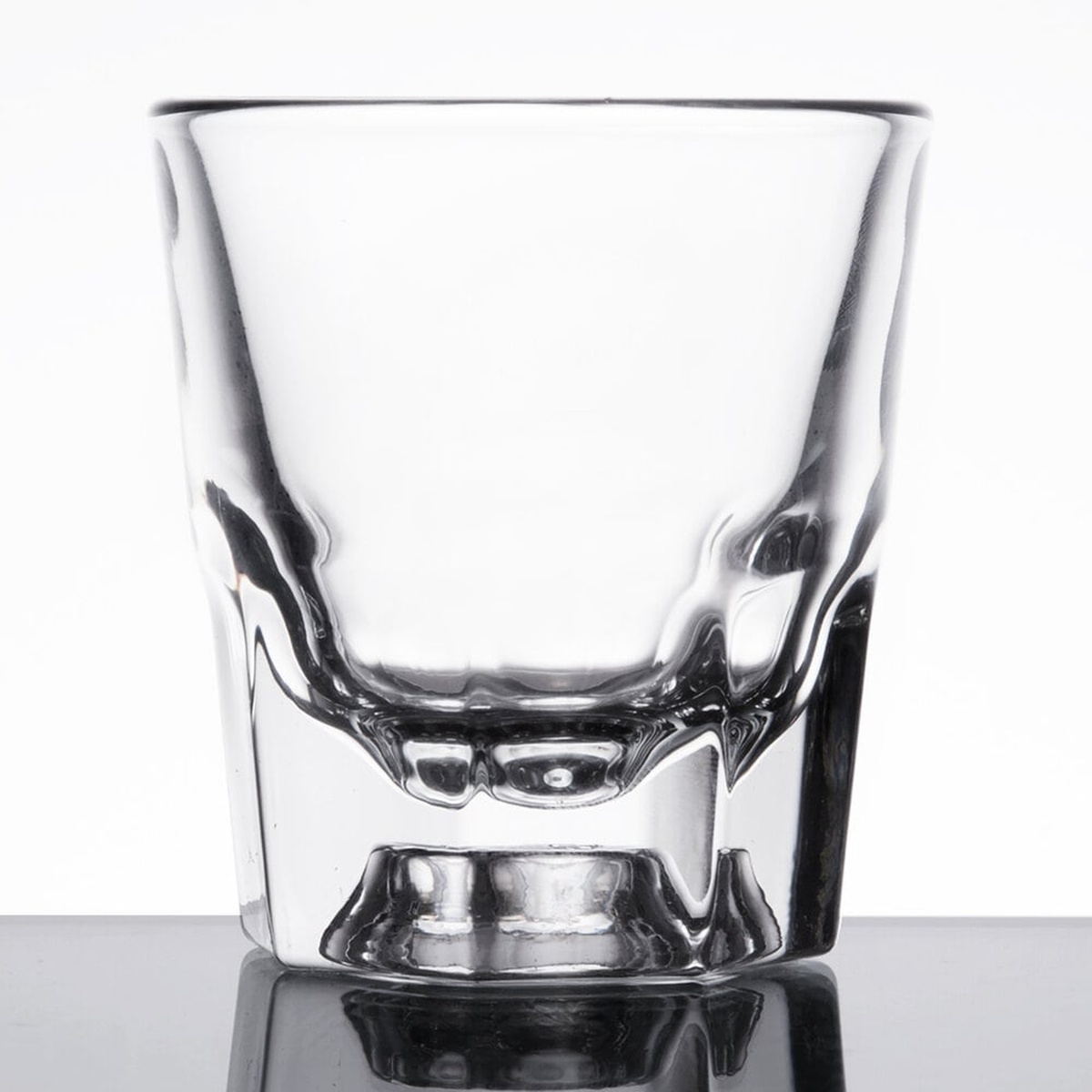 Libbey 5131 4 oz. clear rocks old fashioned glass with paneled base on reflective surface