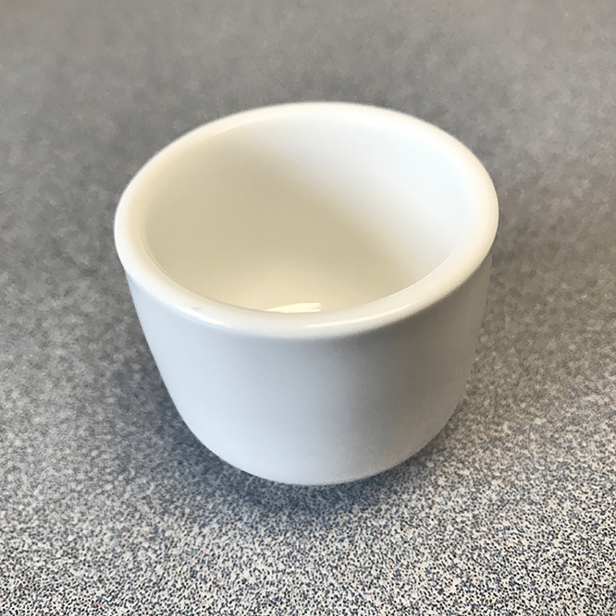 Town Food Service white ceramic sake cup at an angle, showing tapered body and footed base