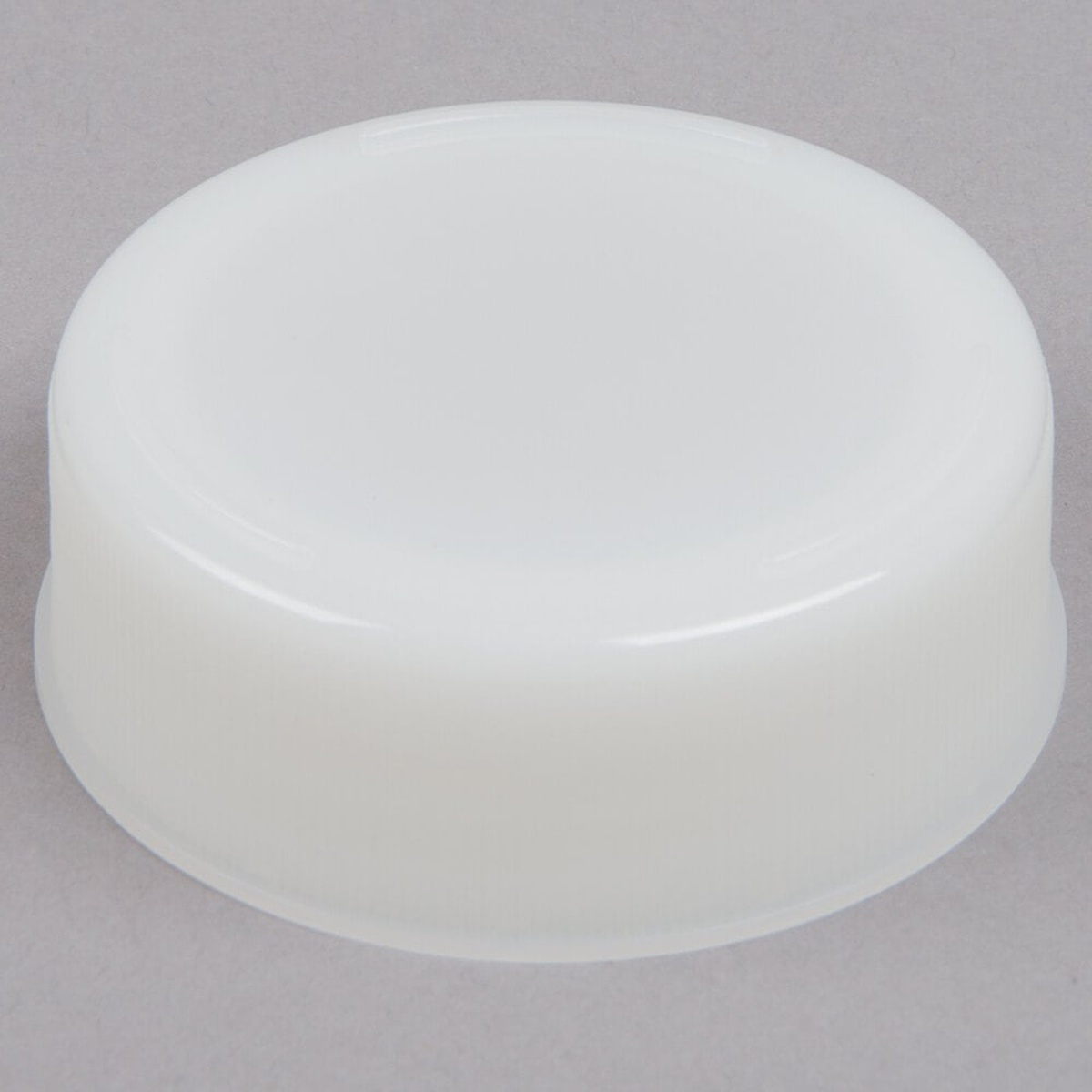 TableCraft 53FCAP solid white polyethylene end cap for 53 mm squeeze bottles, viewed from above at an angle