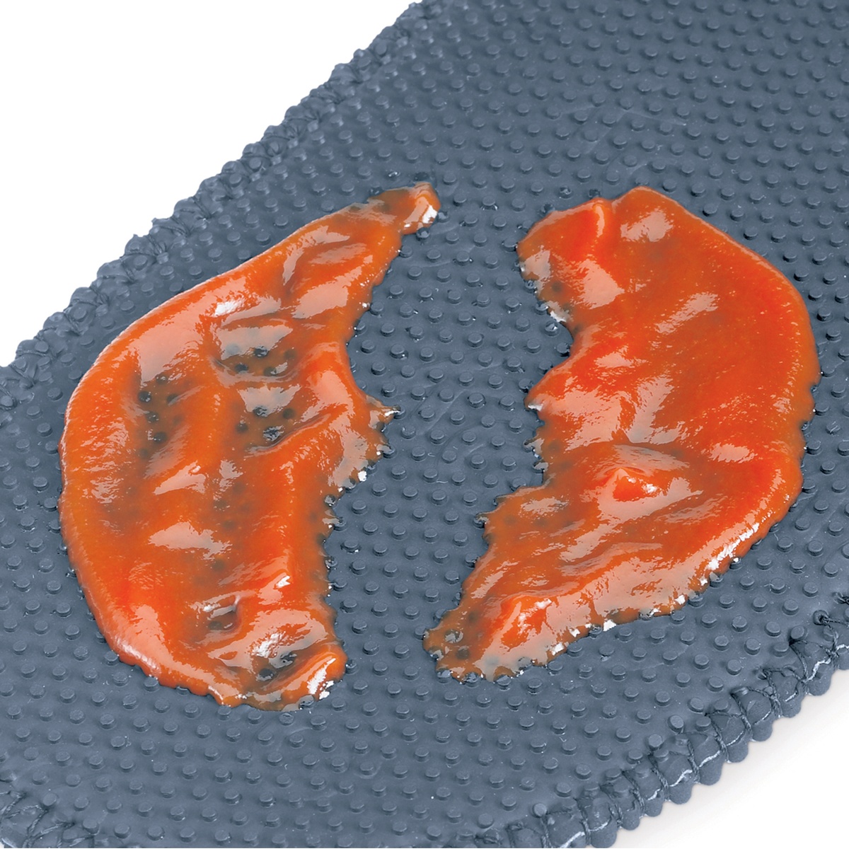 Close-up of oven mitt textured surface with sauce demonstrating stain resistance of FLXaPrene material