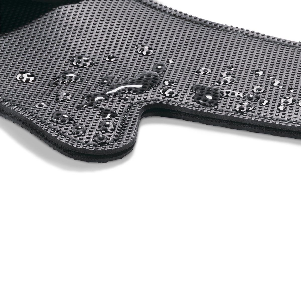 Close-up of black oven mitt textured FLXaPrene surface with water beads showing water repellency